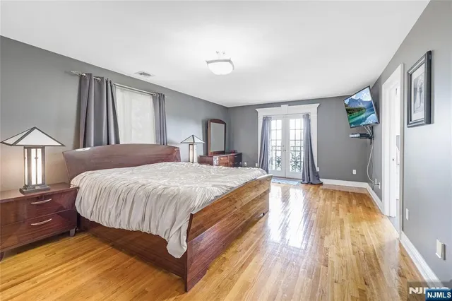 a spacious bedroom with a bed and a large window