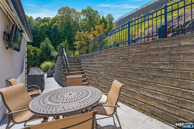 a view of balcony with two chairs and a table