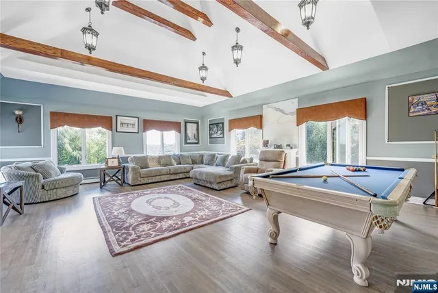 a living room with furniture a rug and a large window