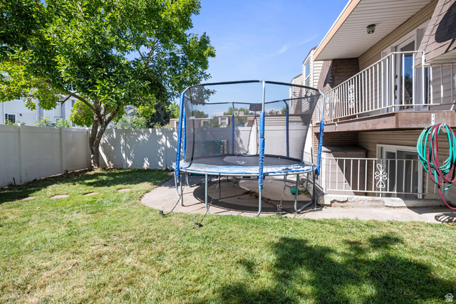 553 North 200 West Bountiful, UT 84010 - Photo 23 of 26 Fenced backyard featuring a trampoline and a patio area