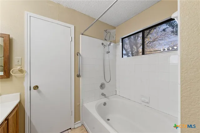 a bathroom with a bathtub and a shower