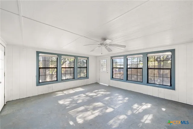 an empty room with windows and entrance