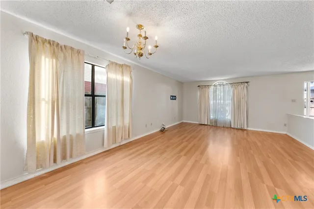 a view of an empty room with a chandelier