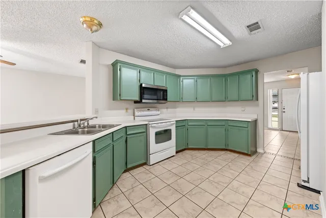a kitchen with a sink and a stove top oven