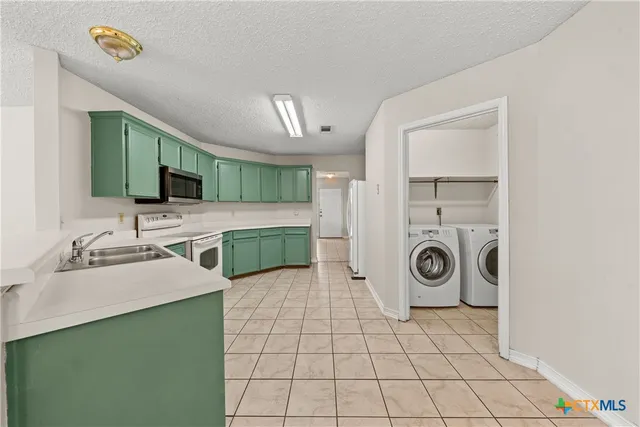 a bathroom with a sink a washer and dryer