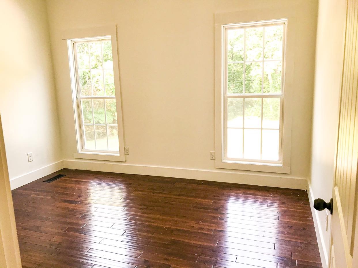 1127 North Corinth Road Portland, TN 37148 - Photo 14 of 18 an empty room with wooden floor and windows