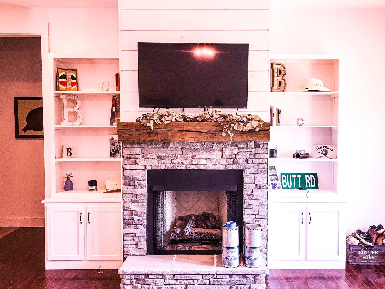 1127 North Corinth Road Portland, TN 37148 - Photo 3 of 18 a living room with a fireplace and a flat screen tv