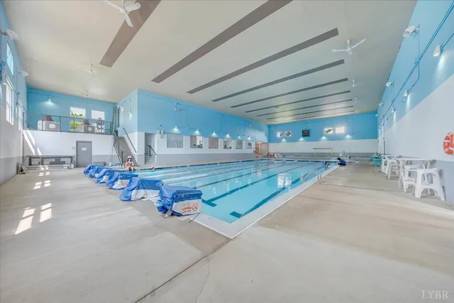 a view of a yard with swimming pool and sitting area