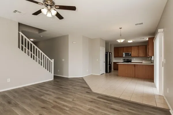 a view of kitchen with sink and refrigerator