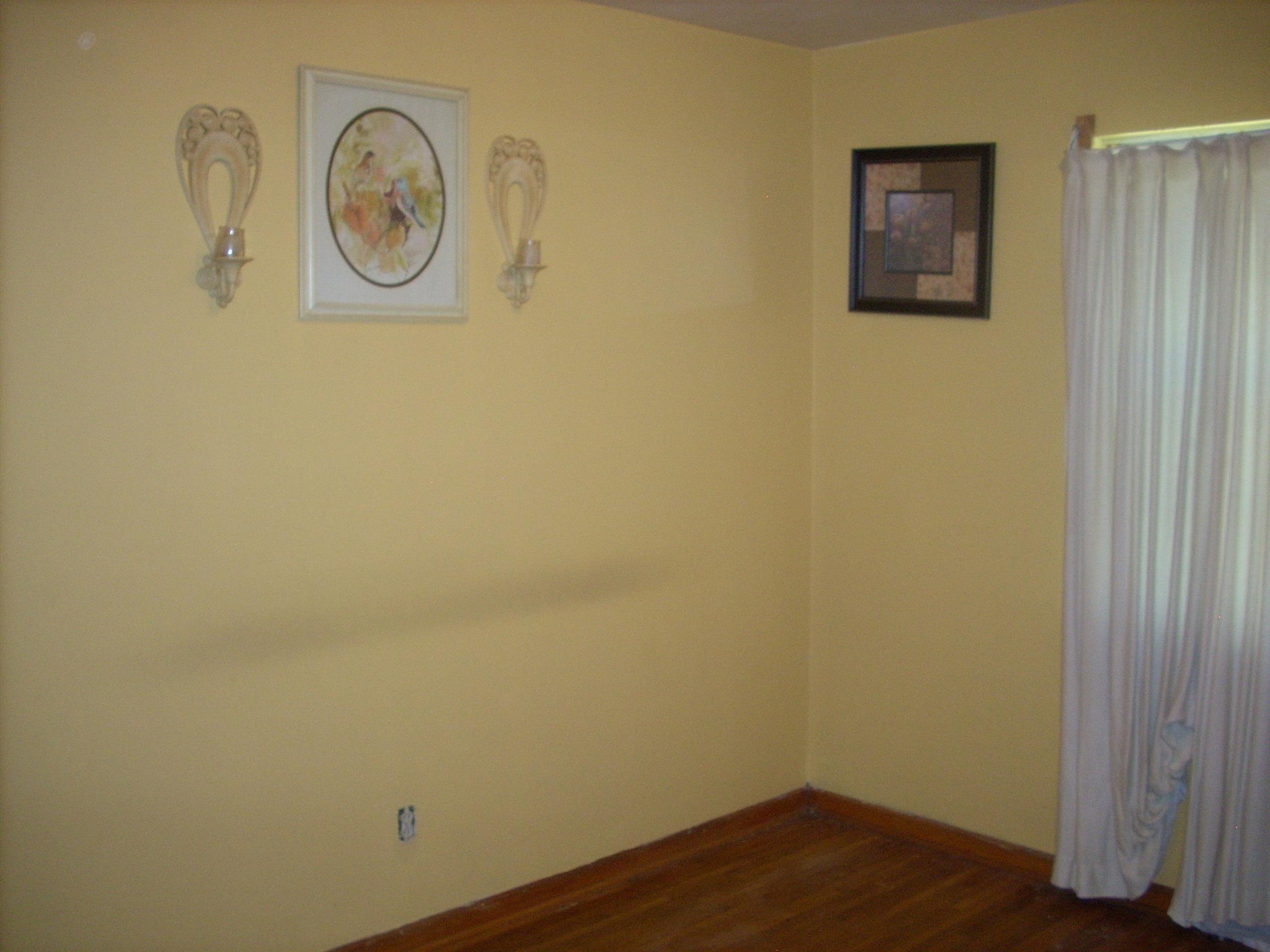 4282 Westmont Road Memphis, TN 38109 - Photo 5 of 15 Room featuring wood-finish flooring, light yellow walls, and a window with drapery