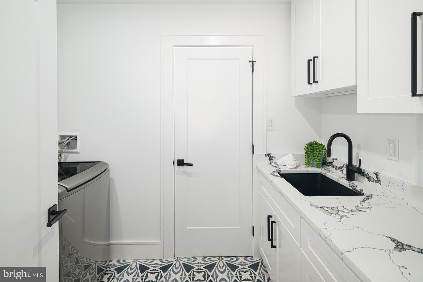2316 Sansom Street Philadelphia, PA 19103 - Photo 27 of 55 Sleek laundry space with stylish accents.