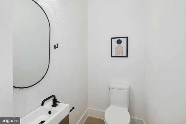 a bathroom with a toilet and a mirror