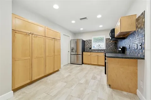 a kitchen with granite countertop cabinets stainless steel appliances and a sink