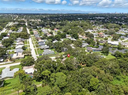 an aerial view of a houses with a yard