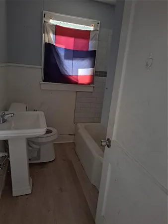 a bathroom with a toilet sink and mirror