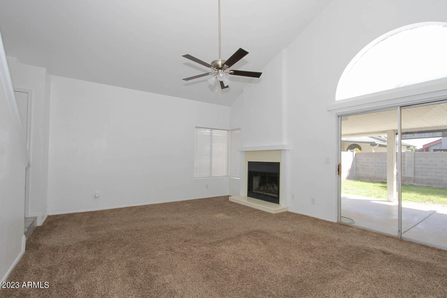 4401 West Tonto Road Glendale, AZ 85308 - Photo 12 of 29 an empty room with a fireplace and fan