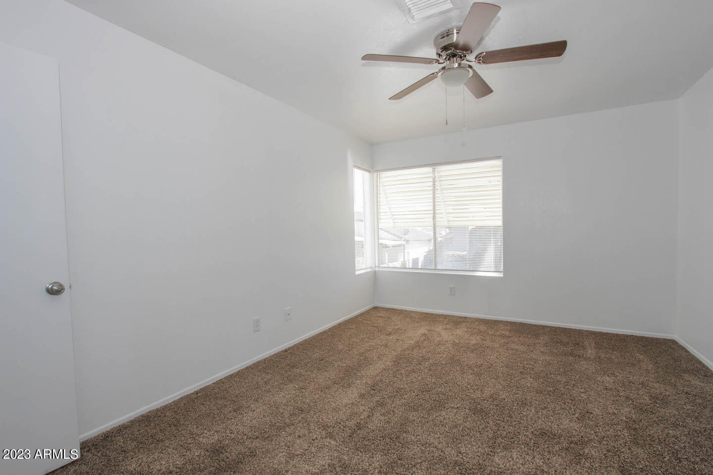 4401 West Tonto Road Glendale, AZ 85308 - Photo 22 of 29 an empty room with windows and fan