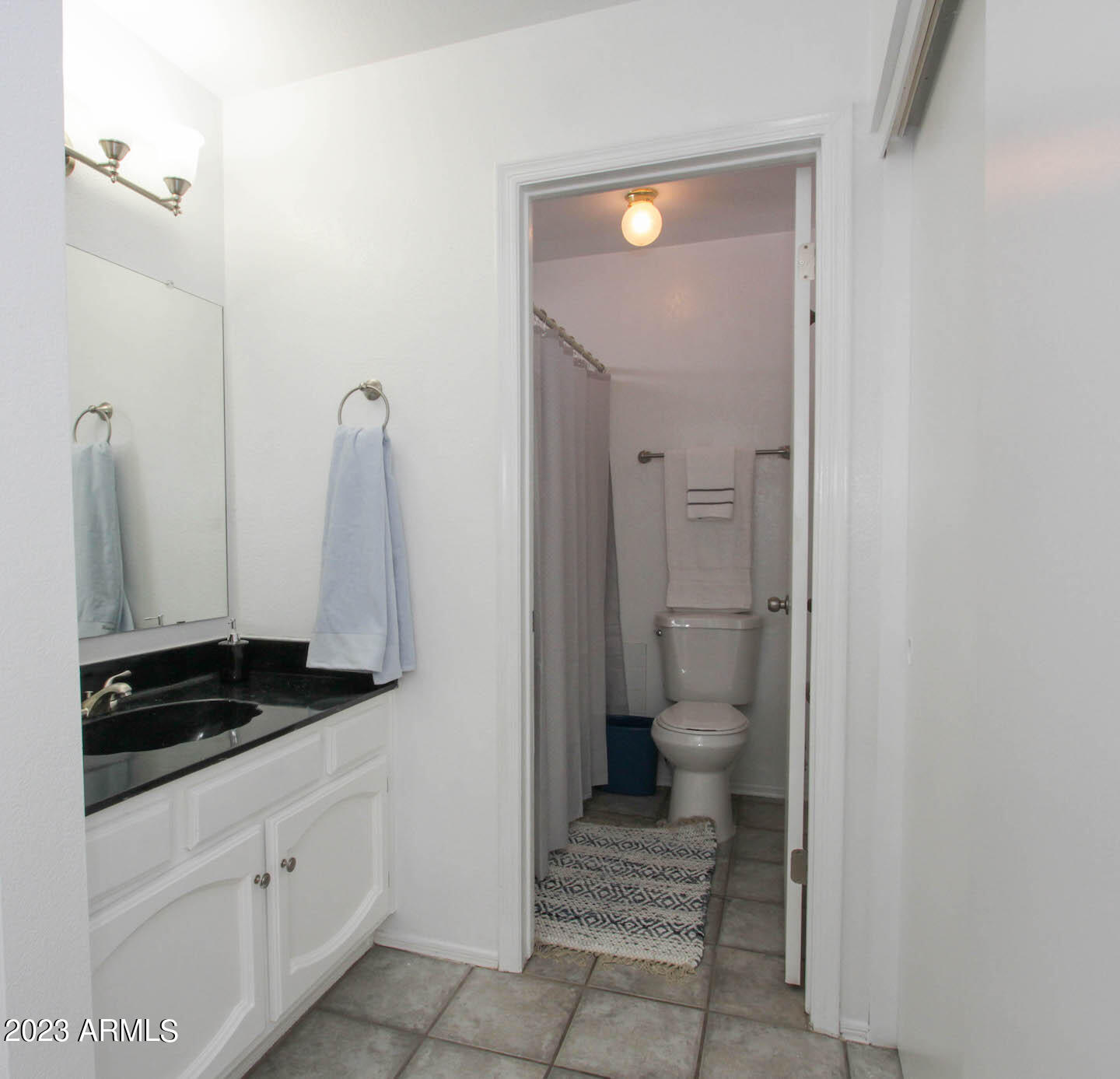 4401 West Tonto Road Glendale, AZ 85308 - Photo 23 of 29 a bathroom with a granite countertop sink and a toilet