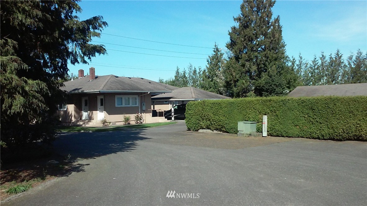 9240 Garrison Road Sumas, WA 98295 - Photo 13 of 16 a front view of a house with a garden and trees
