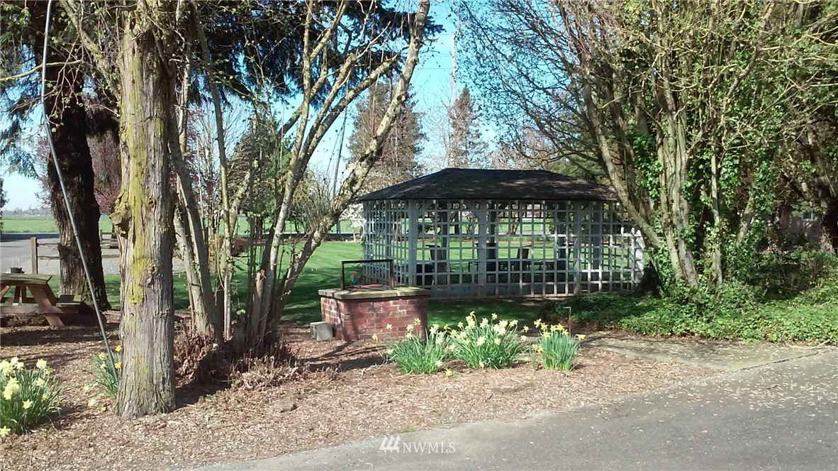 9240 Garrison Road Sumas, WA 98295 - Photo 16 of 16 a view of a table and chairs under an umbrella