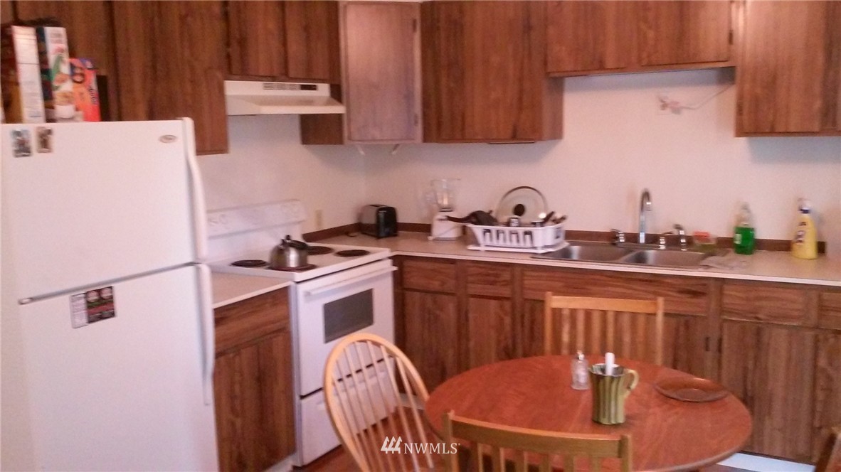 9240 Garrison Road Sumas, WA 98295 - Photo 6 of 16 a kitchen with appliances a sink and cabinets