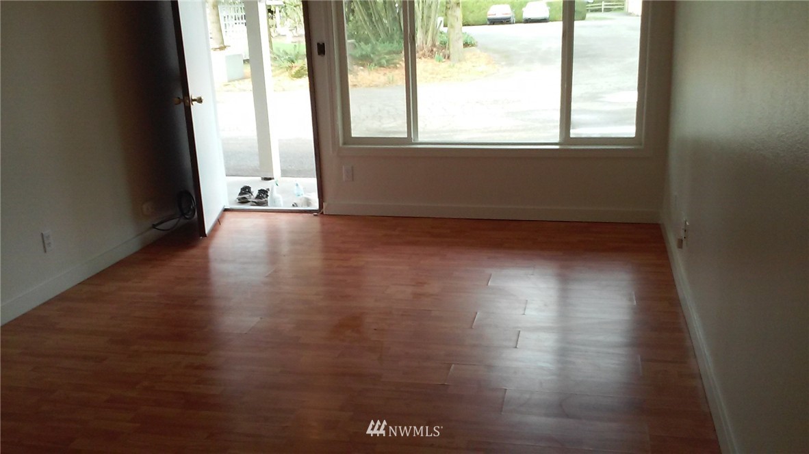 9240 Garrison Road Sumas, WA 98295 - Photo 8 of 16 a view of an empty room with wooden floor and a window