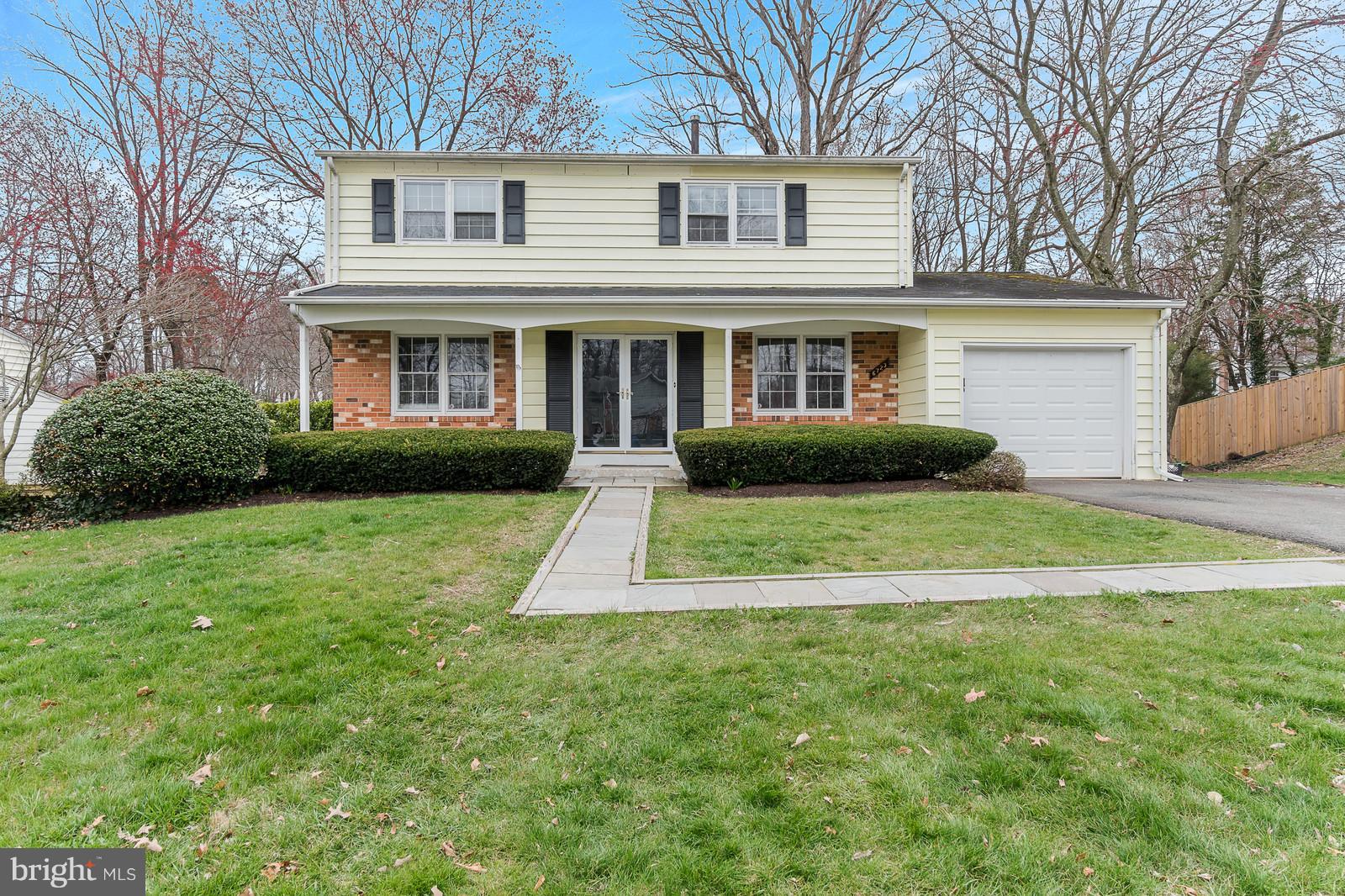 6723 Huntsman Boulevard Springfield, VA 22152 - Photo 1 of 32 a front view of a house with garden