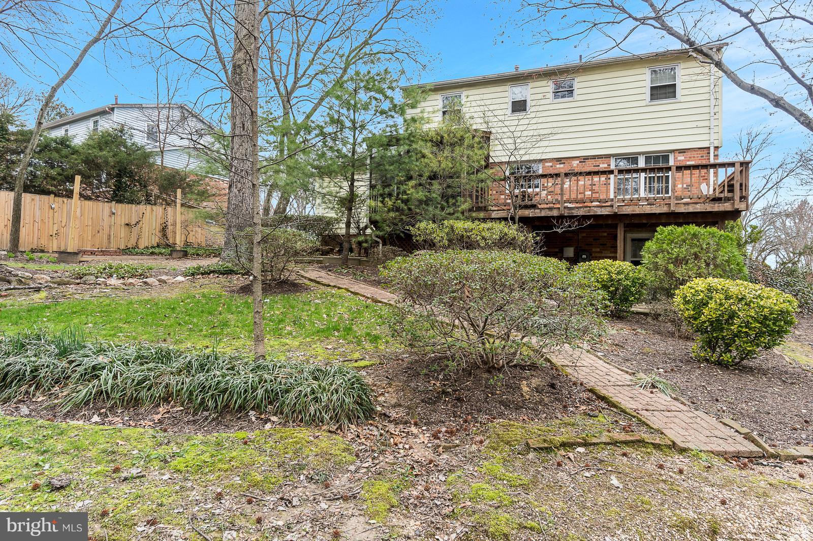 6723 Huntsman Boulevard Springfield, VA 22152 - Photo 11 of 32 a backyard of a house with garden and outdoor seating