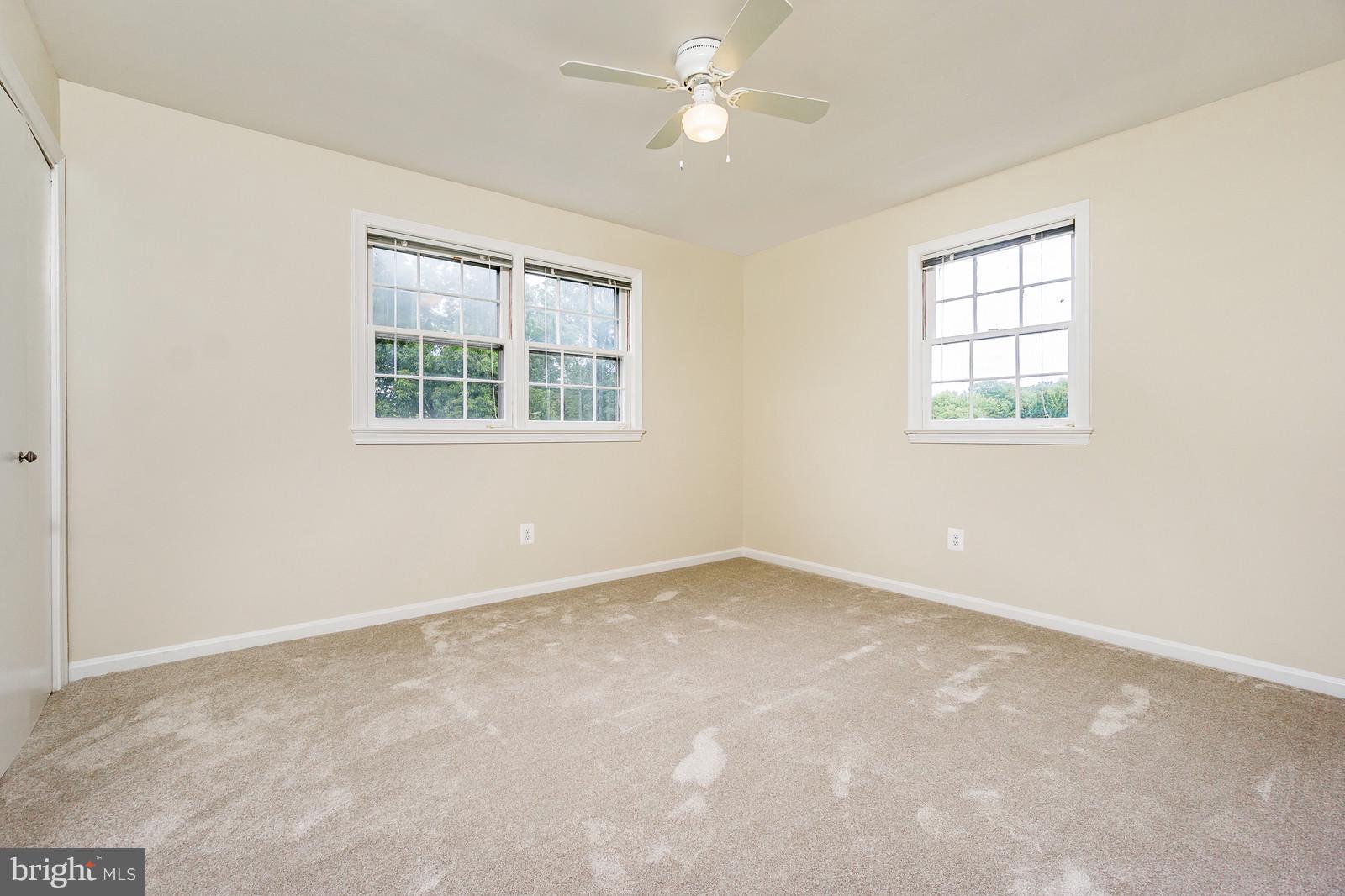 6723 Huntsman Boulevard Springfield, VA 22152 - Photo 16 of 32 an empty room with a window and a fan
