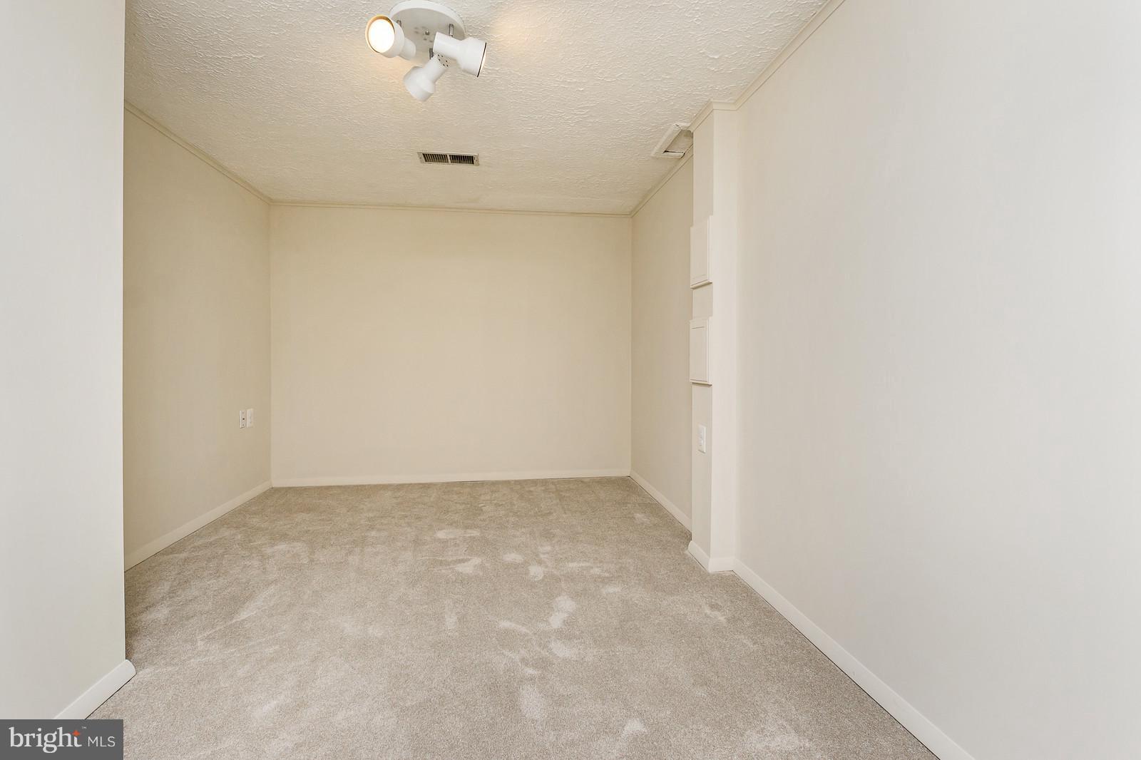 6723 Huntsman Boulevard Springfield, VA 22152 - Photo 19 of 32 an empty room with a ceiling fan and a window