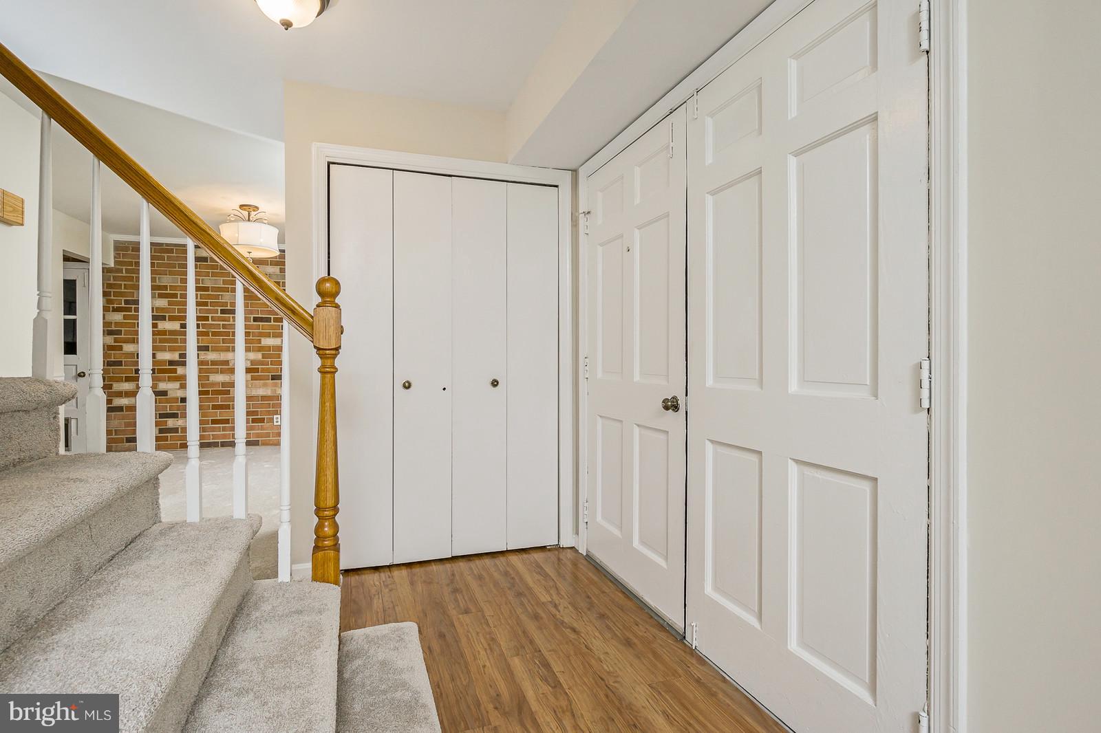 6723 Huntsman Boulevard Springfield, VA 22152 - Photo 3 of 32 a view of a hallway with wooden floor and entryway