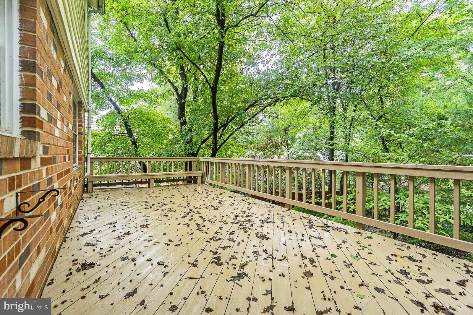 6723 Huntsman Boulevard Springfield, VA 22152 - Photo 10 of 32 a view of balcony with wooden floor and fence