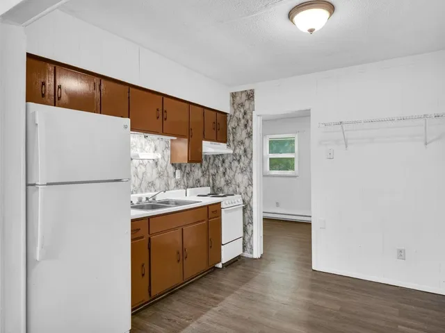 a kitchen with stainless steel appliances a refrigerator and a stove