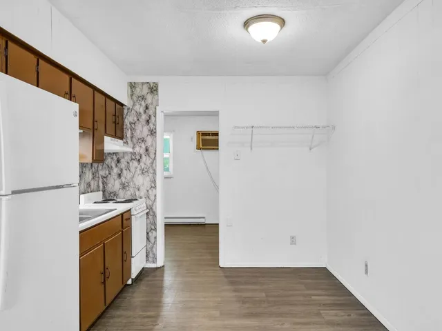 a view of a kitchen with a refrigerator and a stove