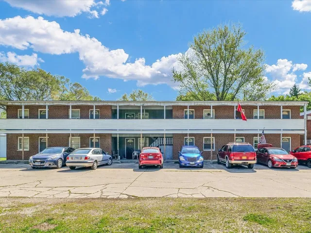 a couple of cars parked in front of a house