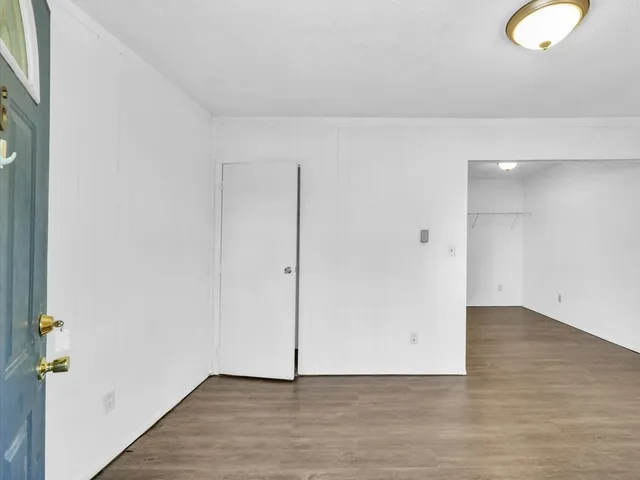 a view of an empty room and wooden floor