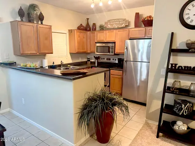 a kitchen with stainless steel appliances a refrigerator a stove a sink and a counter