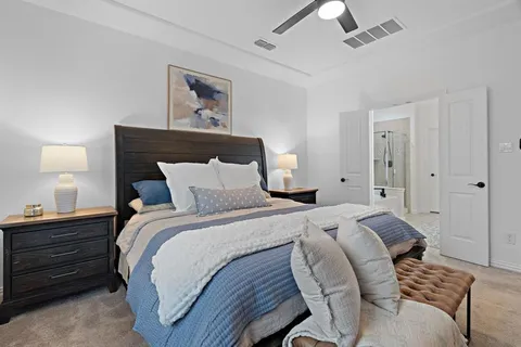 a bedroom with a bed and a lamp