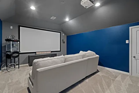 a living room with furniture and a projector screen