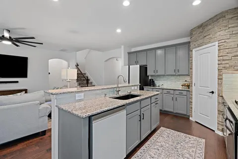 a kitchen with a sink stove and cabinets