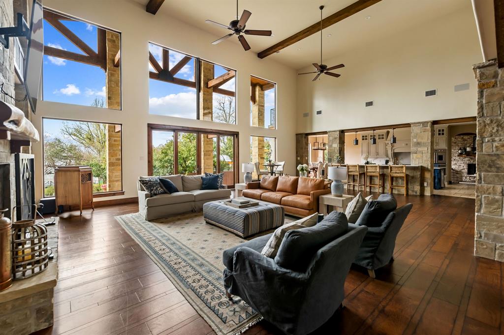 9930 Boat Club Road Fort Worth, TX 76179 - Photo 10 of 40 Main residence great room features beamed sky-high ceilings and floor to ceiling windows providing stunning views of the water.