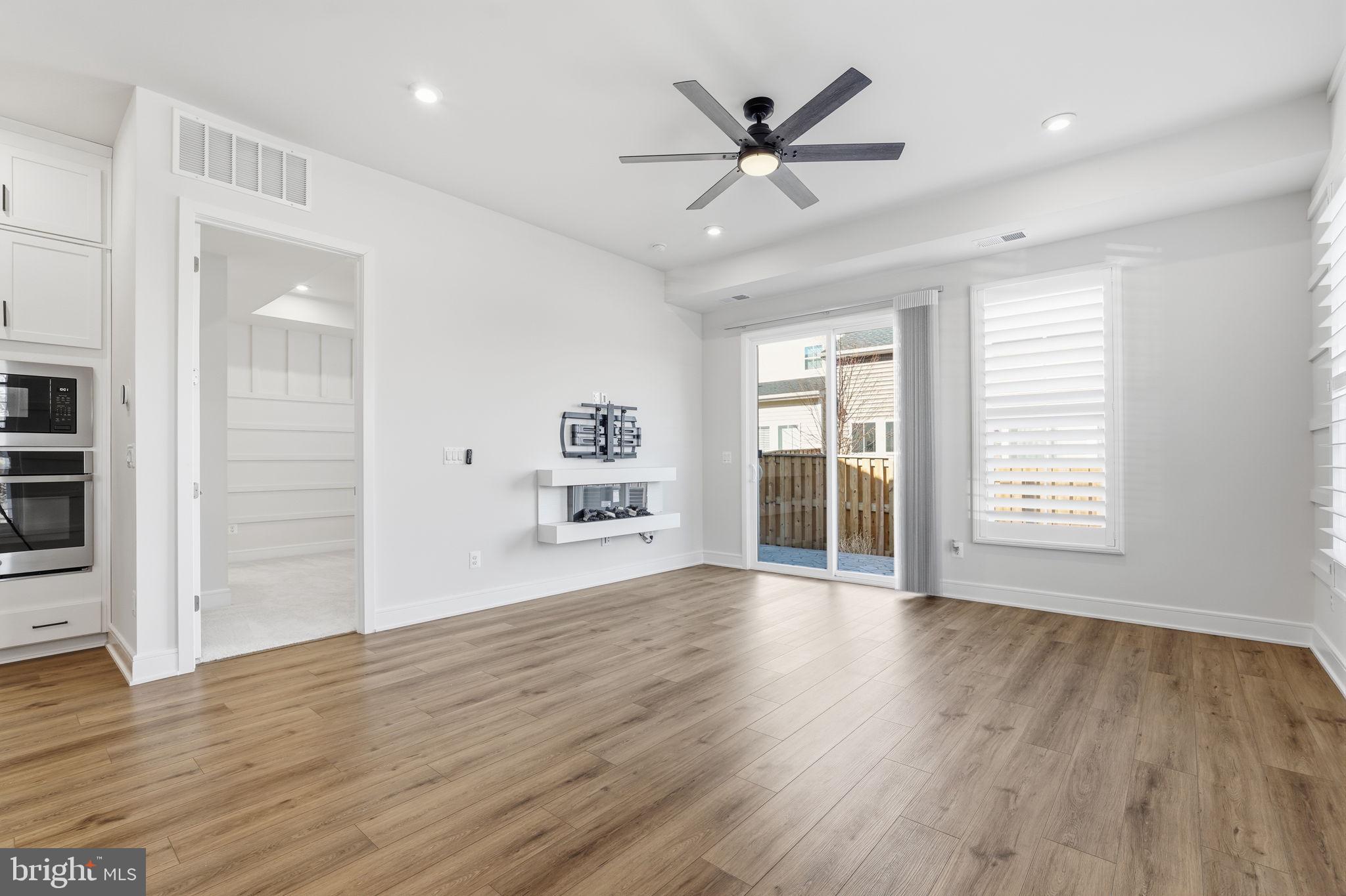 14679 Grand Cru Loop Gainesville, VA 20155 - Photo 11 of 41 a view of an empty room with wooden floor and a window
