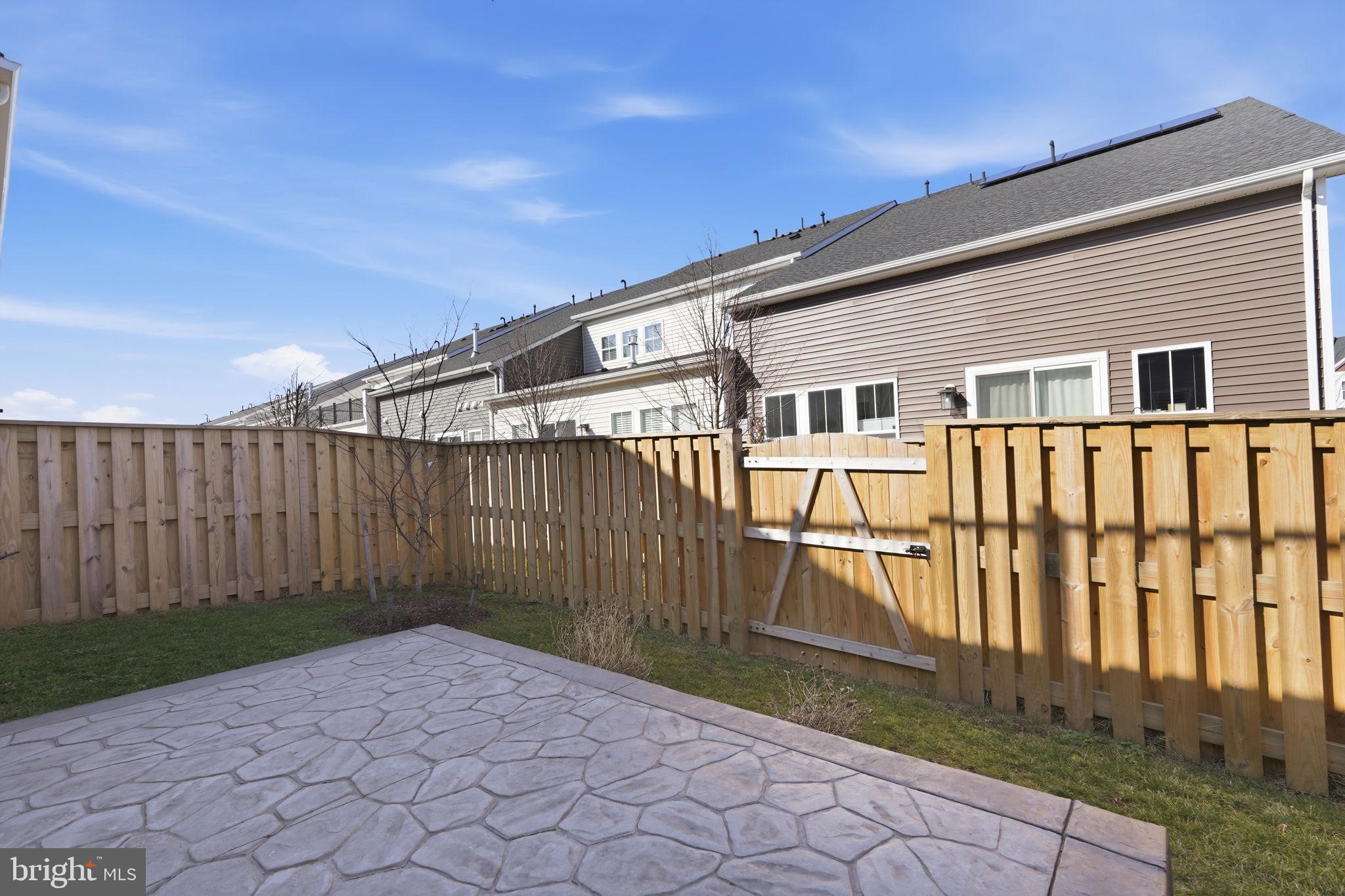 14679 Grand Cru Loop Gainesville, VA 20155 - Photo 12 of 41 a view of a house with wooden fence