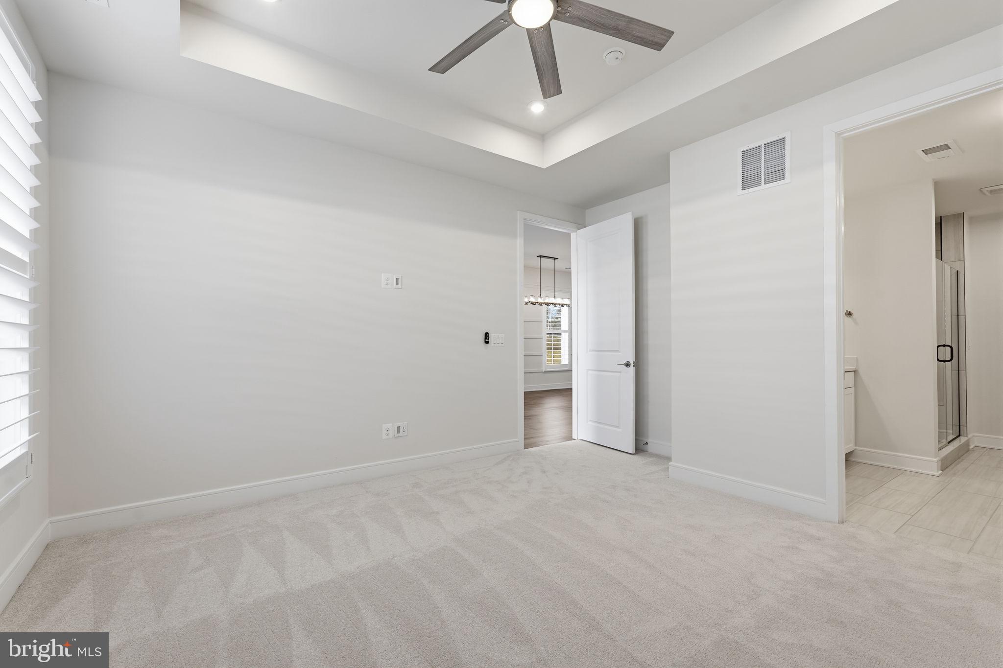 14679 Grand Cru Loop Gainesville, VA 20155 - Photo 16 of 41 an empty room with chandelier fan and windows