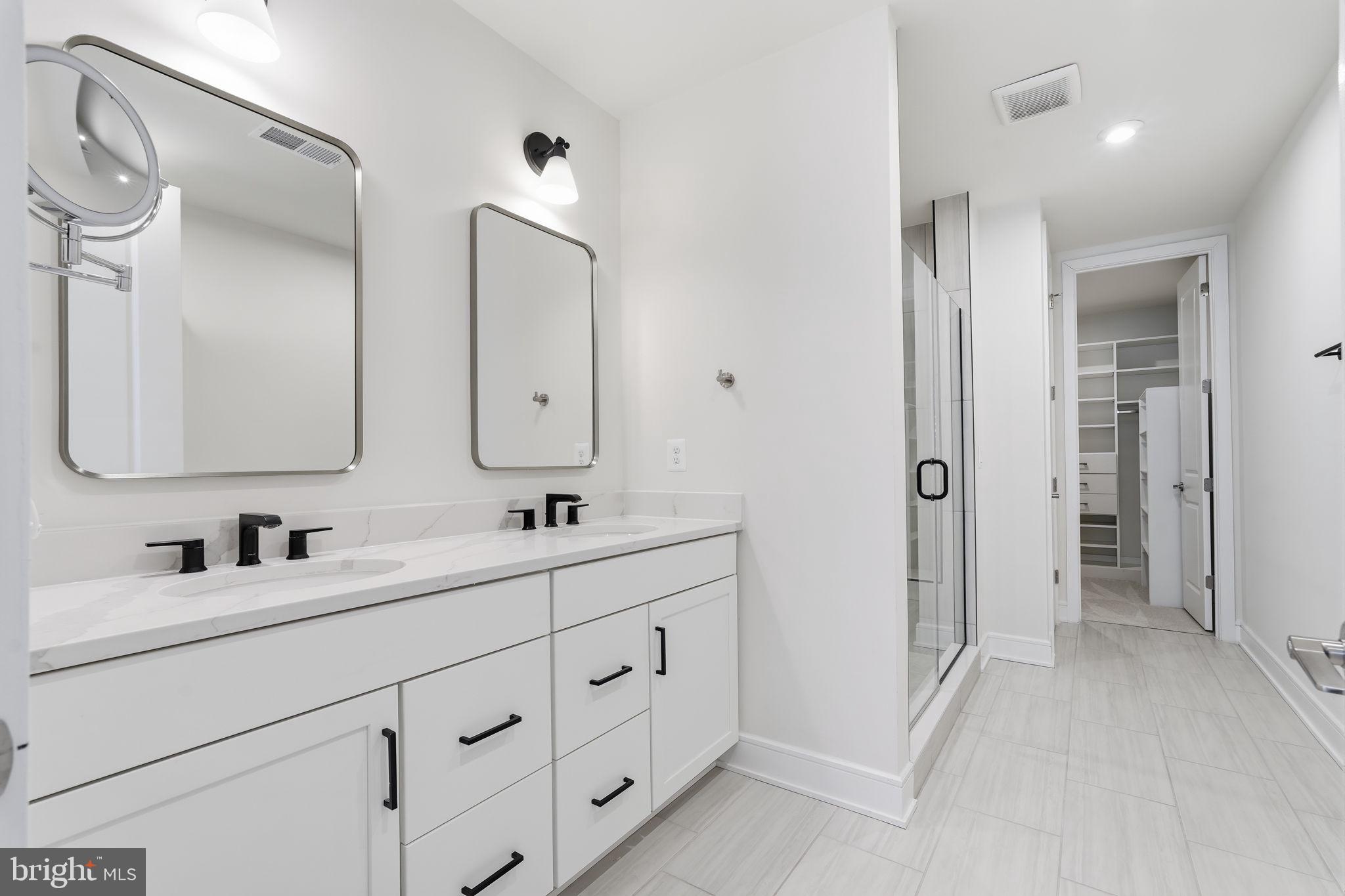 14679 Grand Cru Loop Gainesville, VA 20155 - Photo 17 of 41 a bathroom with double vanity sinks double vanity and a mirror