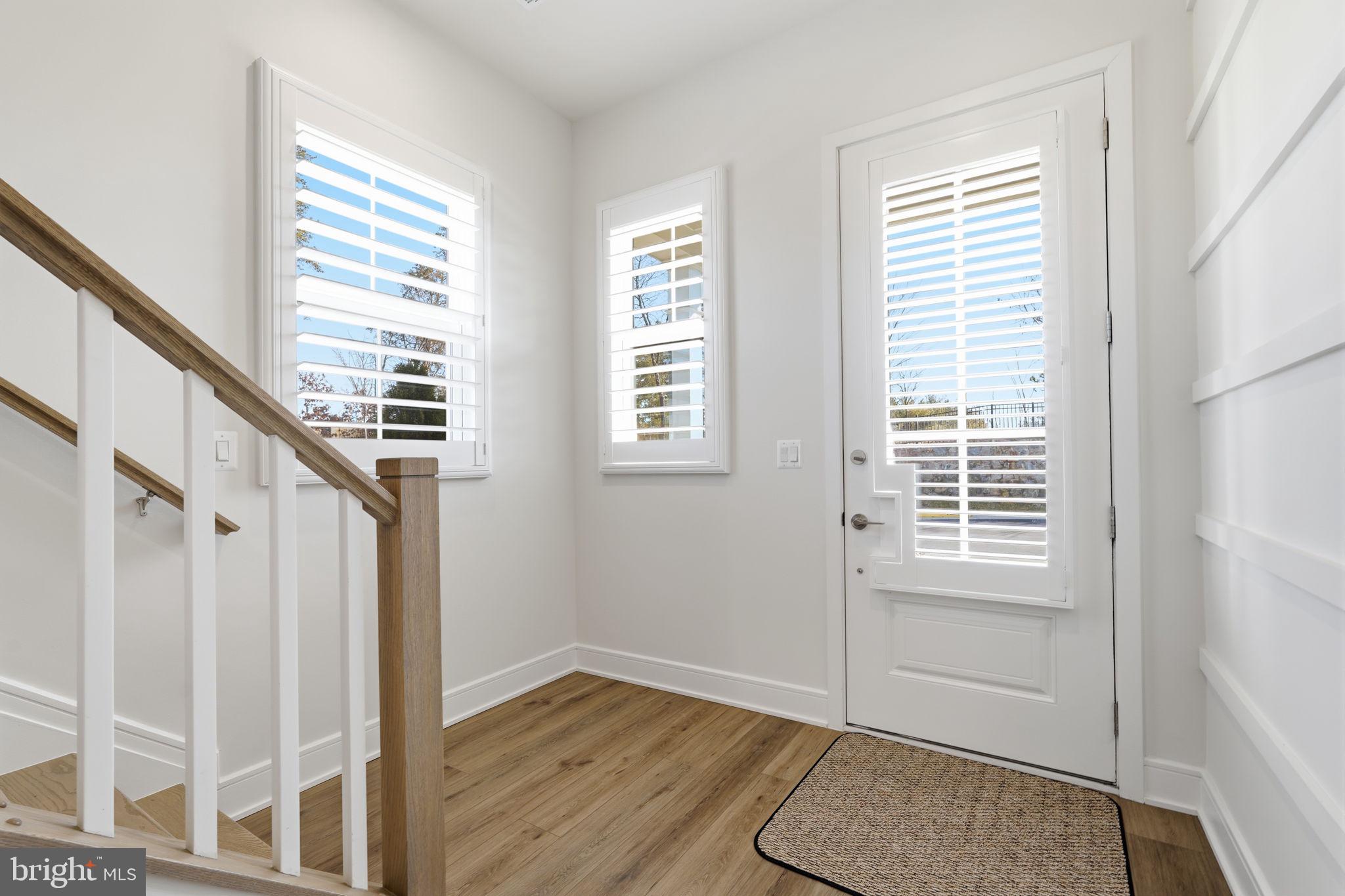 14679 Grand Cru Loop Gainesville, VA 20155 - Photo 2 of 41 a view of an empty room with wooden floor and a window