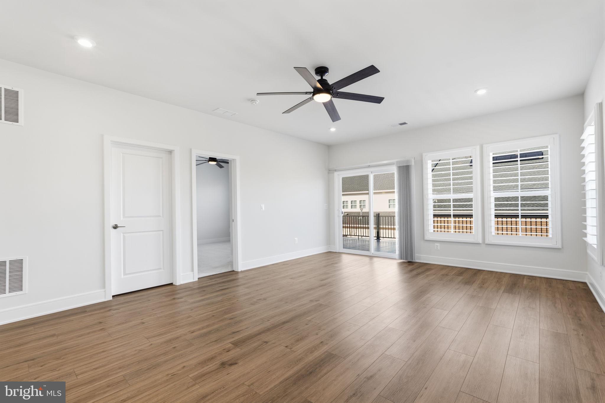 14679 Grand Cru Loop Gainesville, VA 20155 - Photo 22 of 41 a view of an empty room with wooden floor and a window