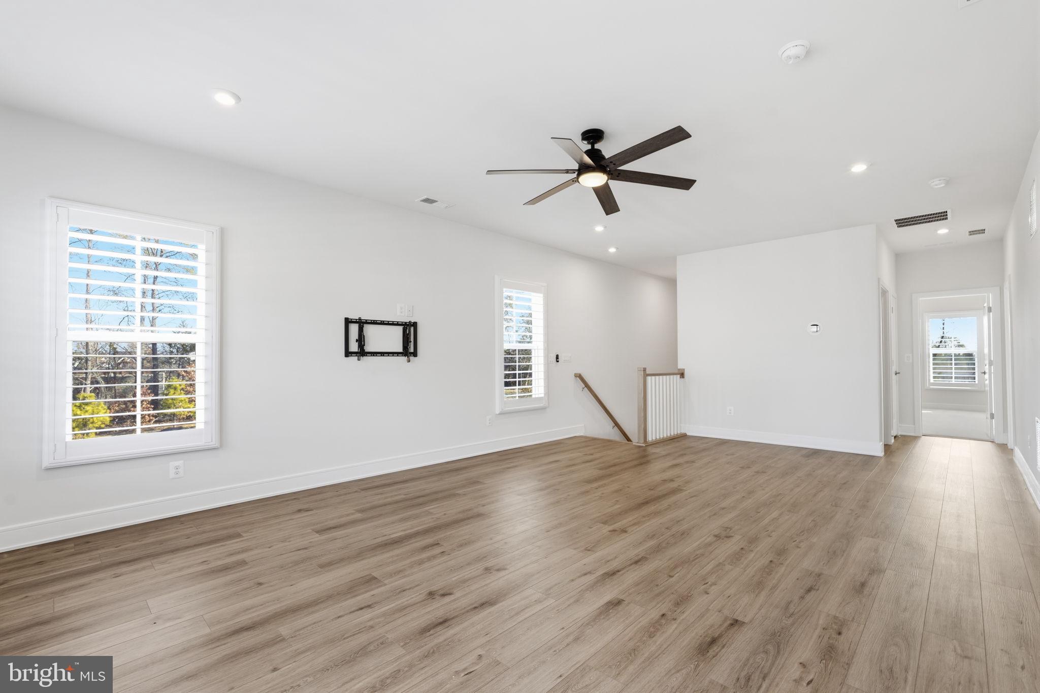 14679 Grand Cru Loop Gainesville, VA 20155 - Photo 23 of 41 a view of empty room with wooden floor and ceiling fan