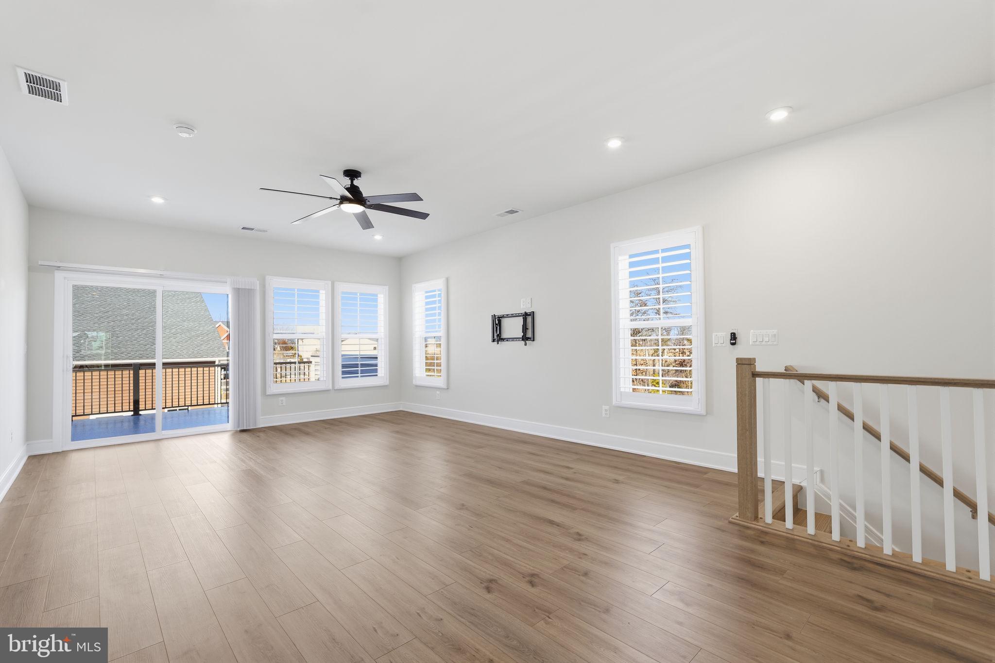 14679 Grand Cru Loop Gainesville, VA 20155 - Photo 24 of 41 a view of an empty room with a window and wooden floor