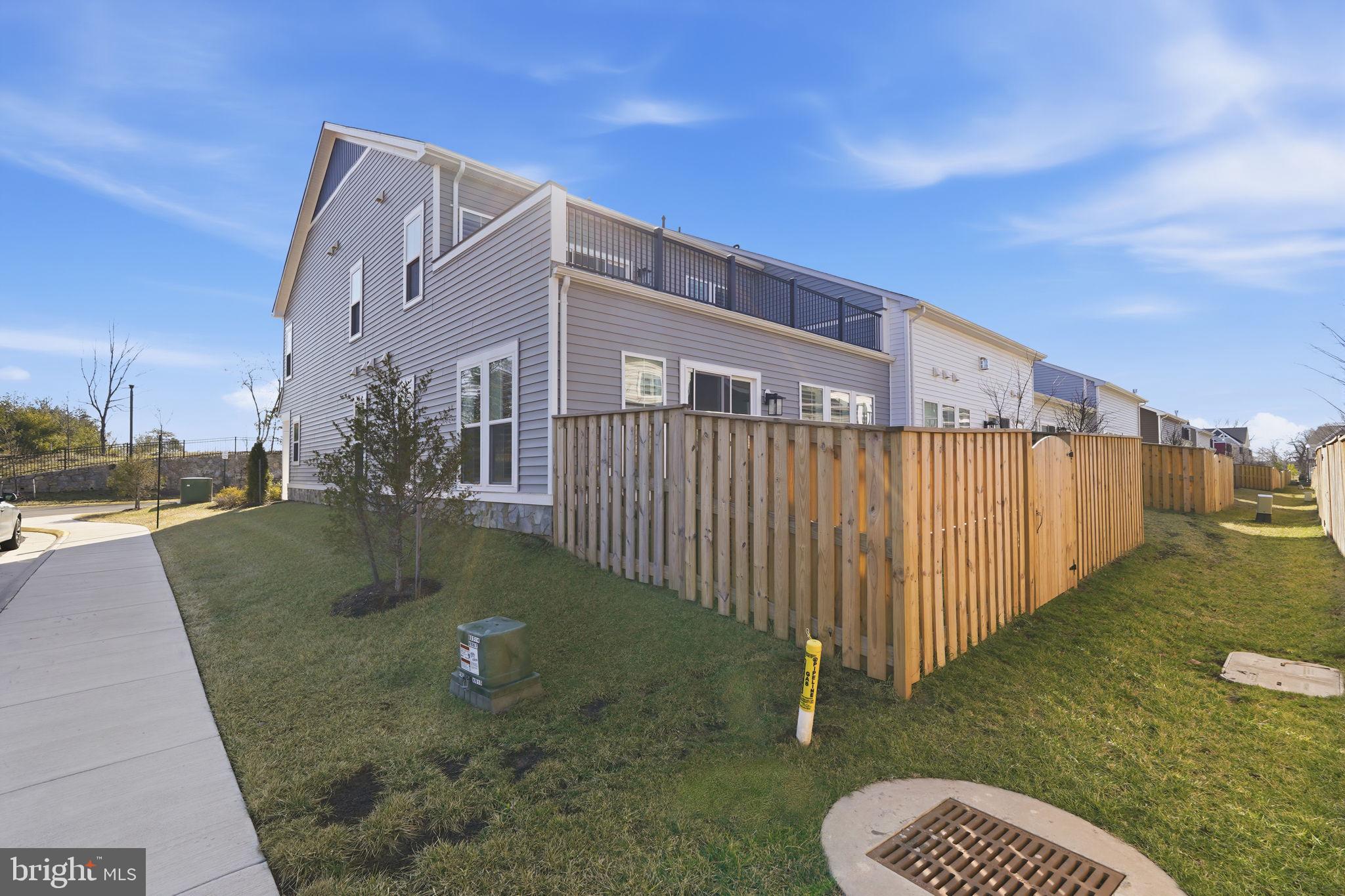 14679 Grand Cru Loop Gainesville, VA 20155 - Photo 35 of 41 a view of a street with a yard